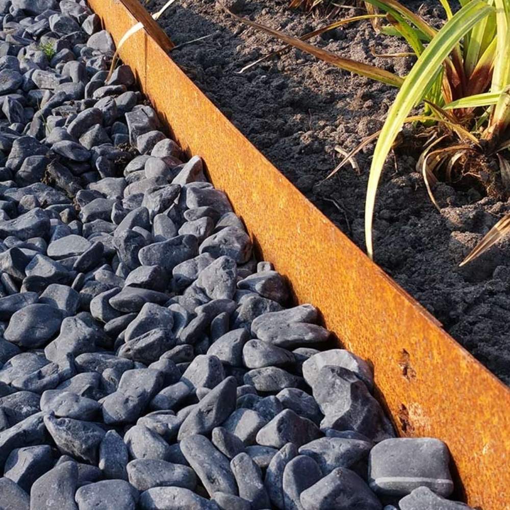 Pre-rusted coreten steel garden edging holding a bed line